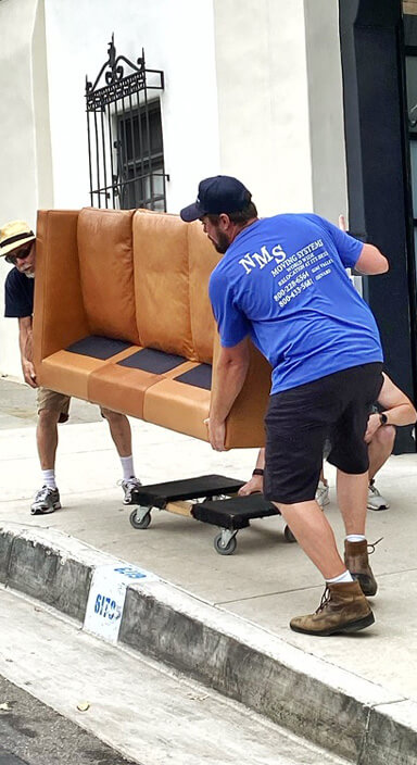 NMS crew members carrying a sofa